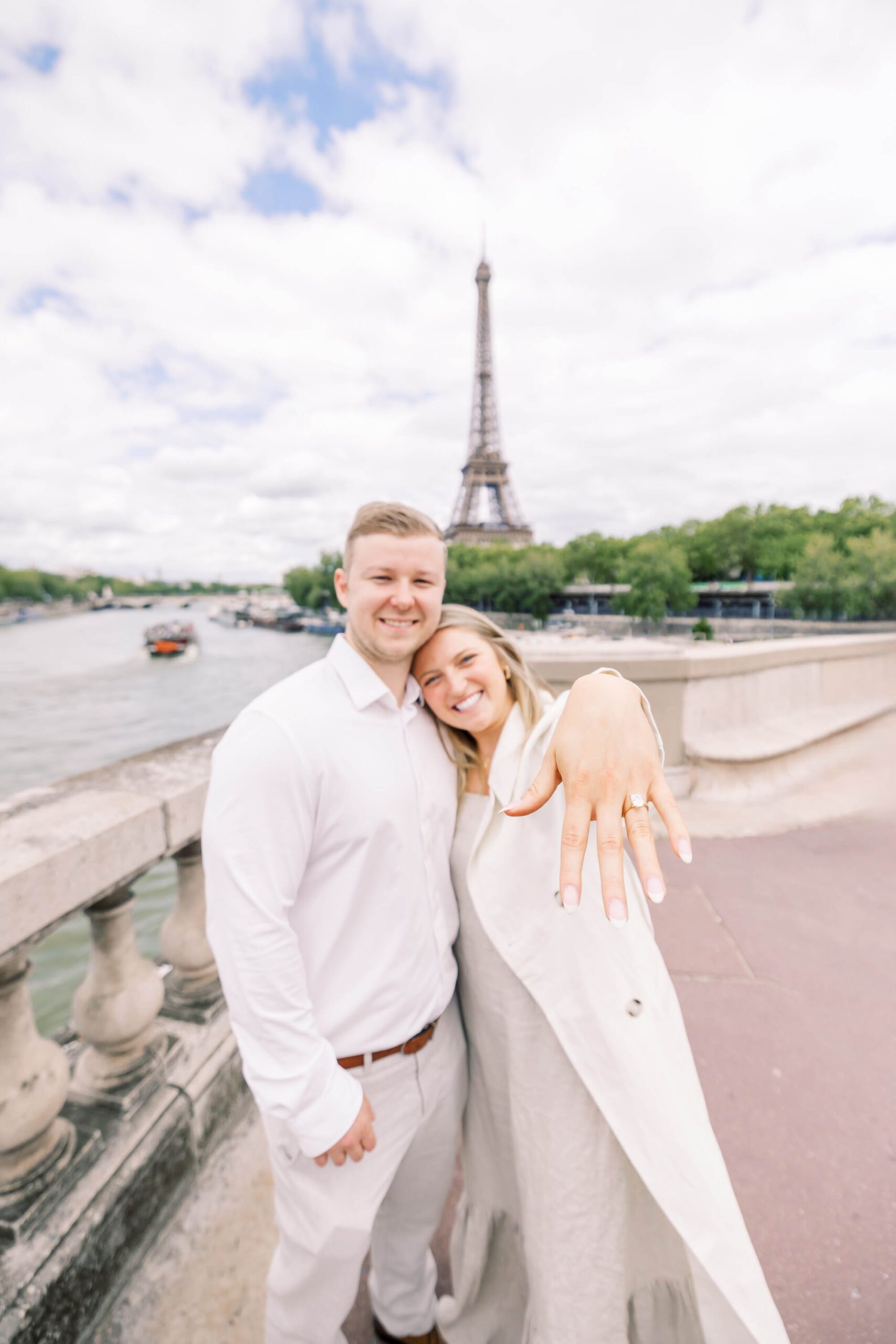 girl showing off engagement ring at eiffel tower after proposal