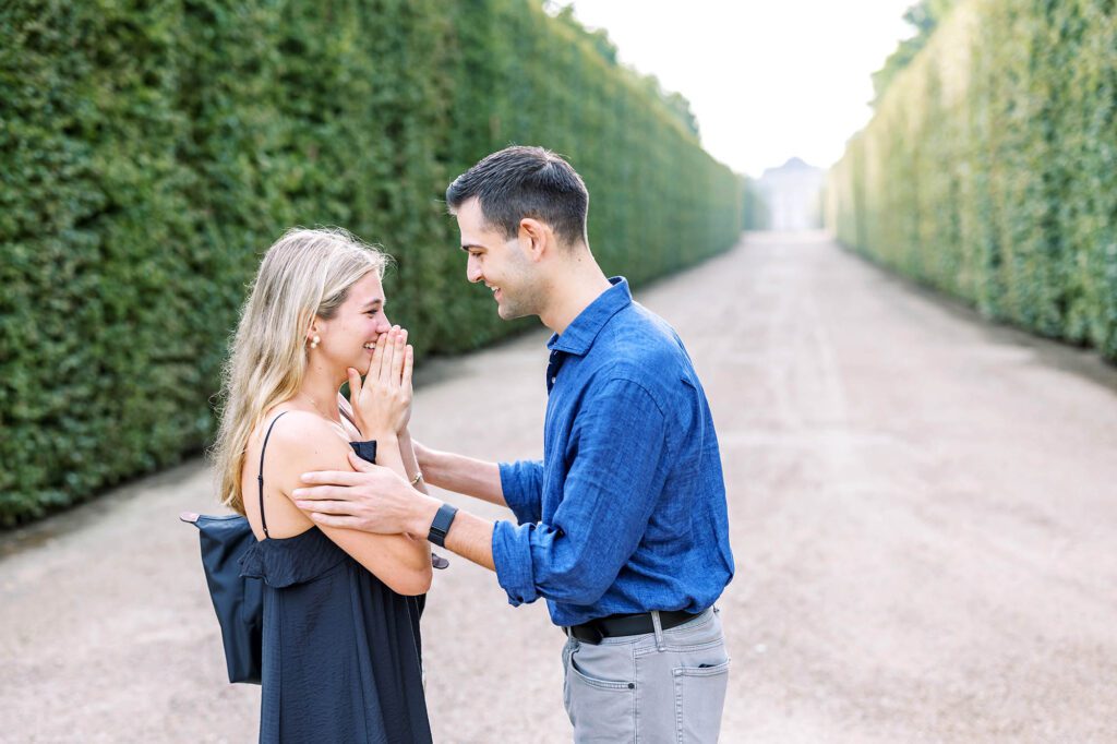 a girl surprised with a marriage proposal in the gardens of versailles