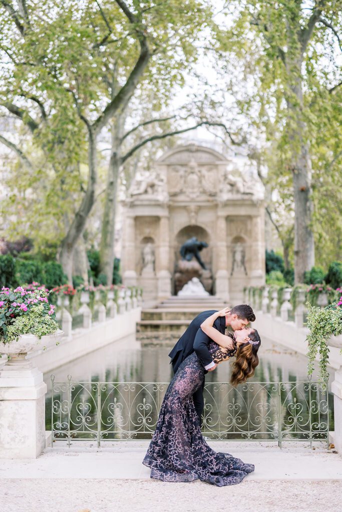 a couple eloping in front of the Medici Fountain in Jardin du Luxembourg in Paris