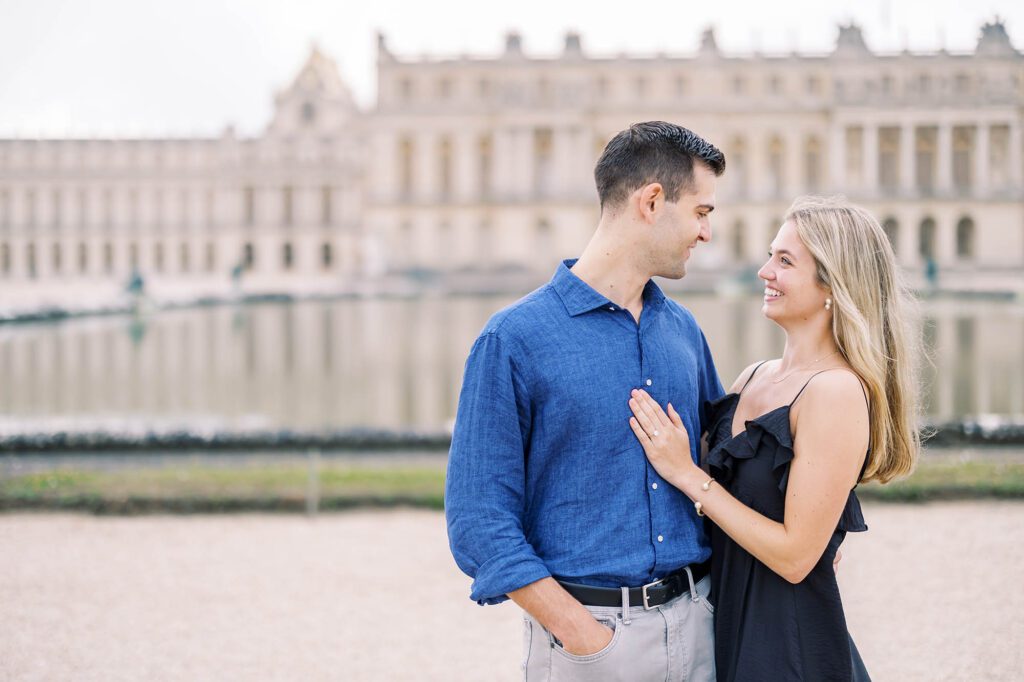 romantic portrait of a couple at the palace of versailles behind the palace