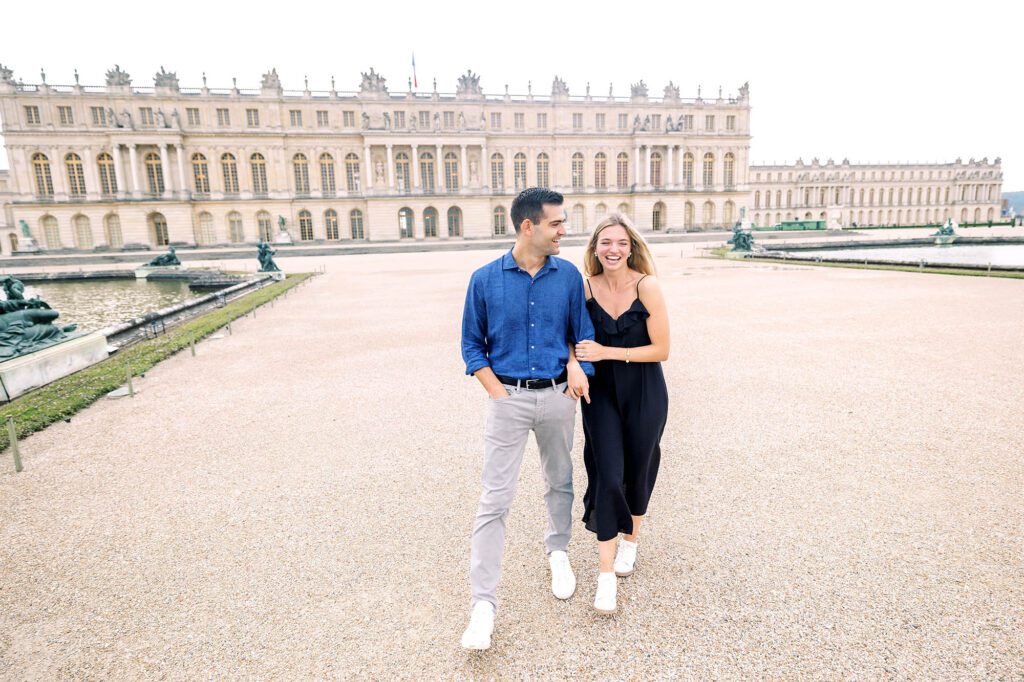 couple laughing and walking together after their engagement in versailles